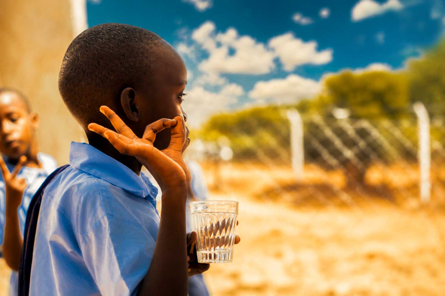Child drinking clean water in Rwanda